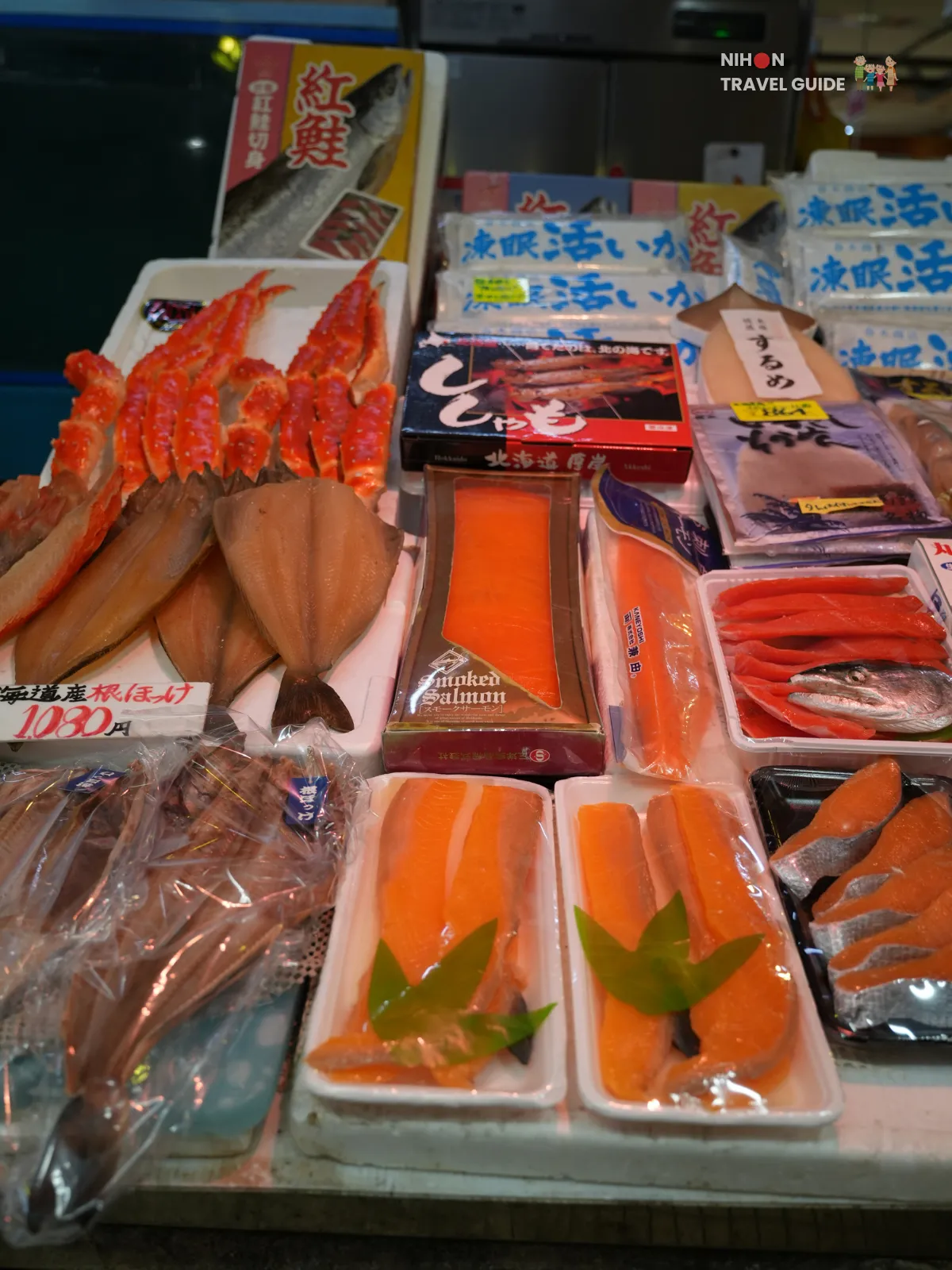 Display of crab legs, salmon fillets, and packaged seafood arranged together at Hakodate Morning Market.