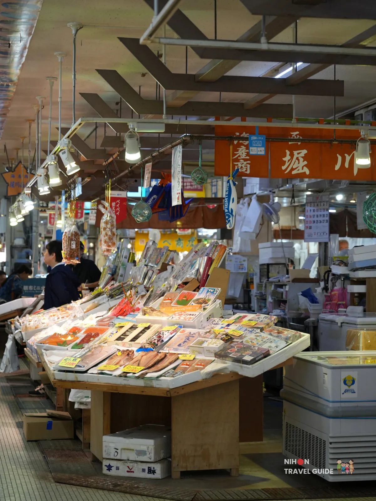 Long indoor aisle of dried seafood stalls at Hakodate Morning Market in Hokkaido, Japan.