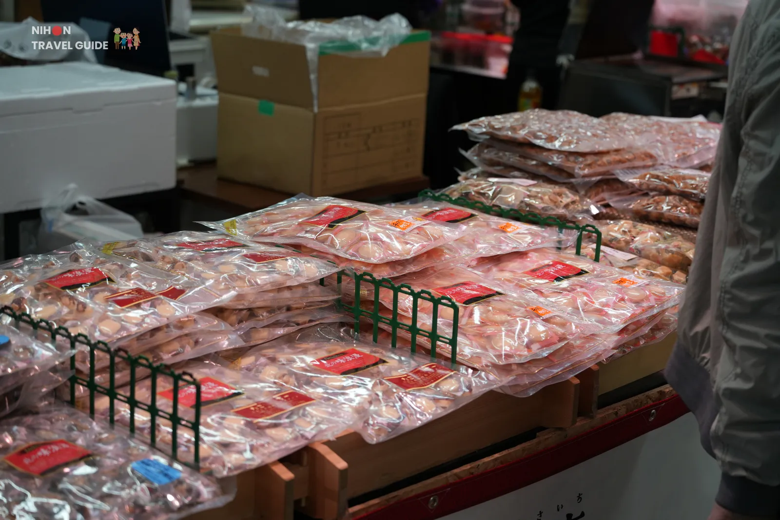 Stacks of vacuum-packed seafood snacks arranged on a counter at Hakodate Morning Market.