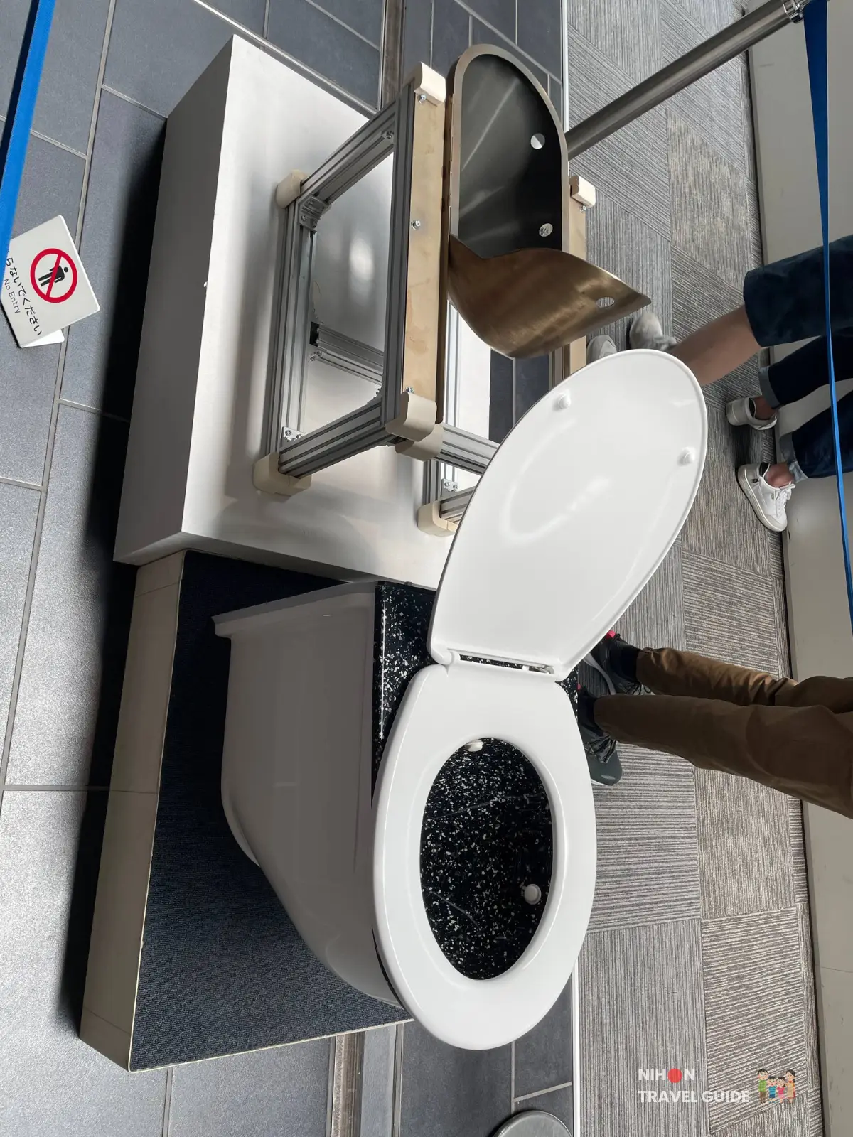 Cutaway exhibit of a Shinkansen train toilet at SCMaglev and Railway Park showing the bowl and inner waste tank mechanisms.