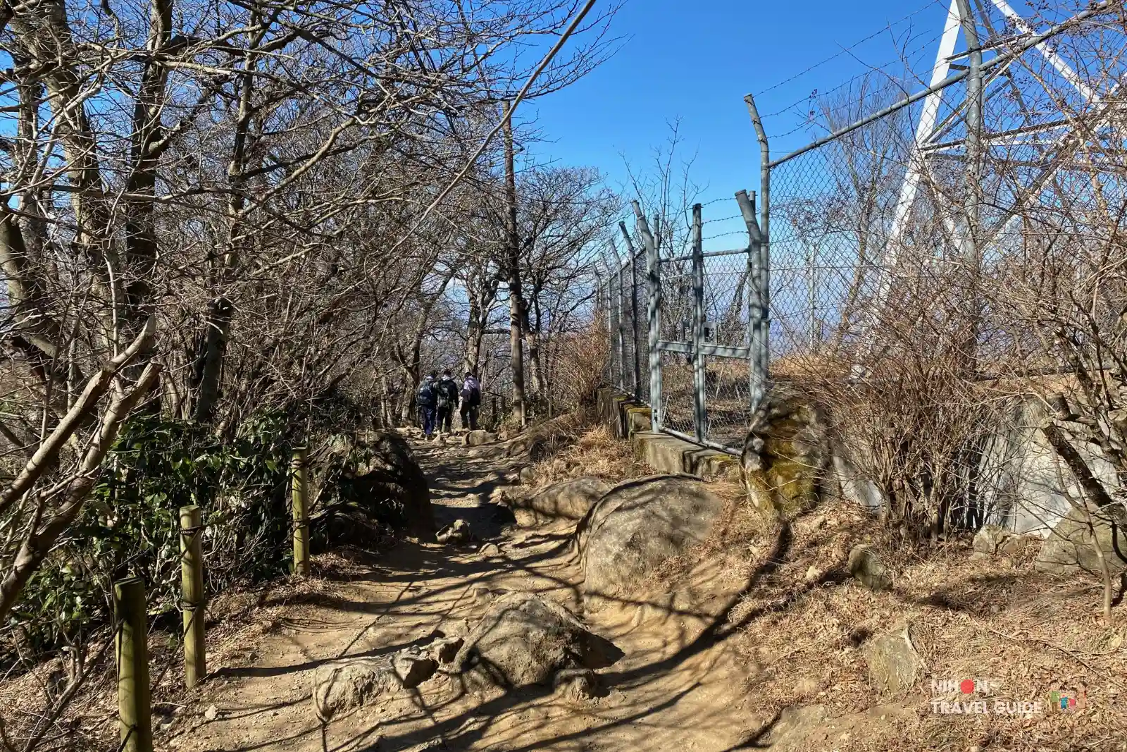Rocky trail on Mount Tsukuba passing by the fenced meteorological observation station on the way to the Summit Village