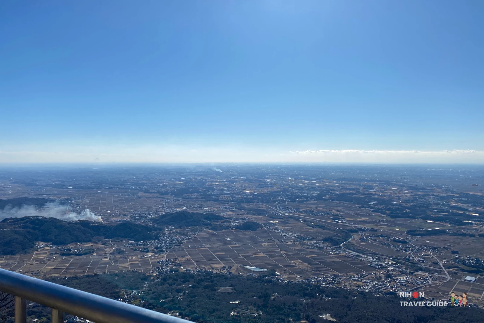 Panorama from Nantaisan Peak showing terraced hills, towns, and winding rivers spread across the Kanto Plain.