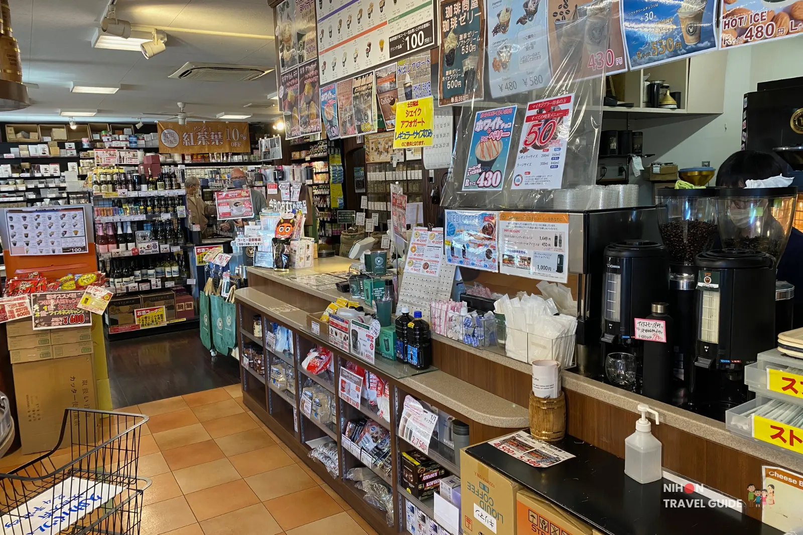Interior of Tonya Coffee shop in Tsukuba with coffee beans, drinks menu, and busy counter area.