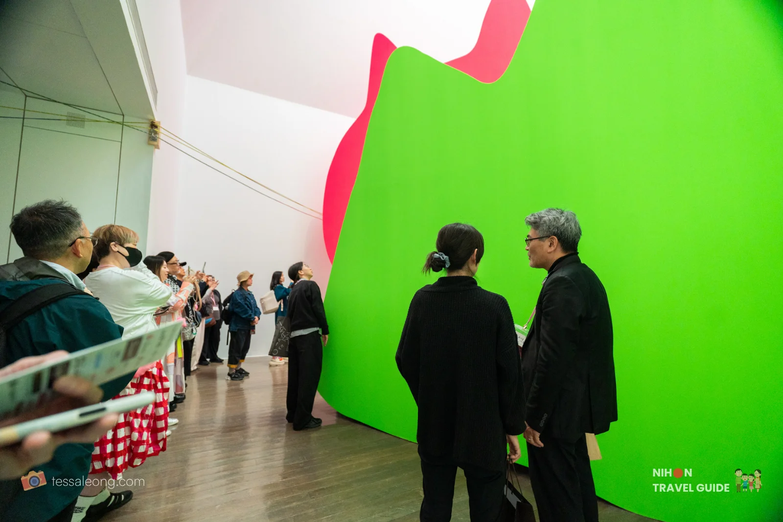 Visitors viewing Mr. Kobayashi the Pink Cat large-scale green and pink installation by Takehiro Iikawa at the Contemporary Art Gallery, Art Tower Mito