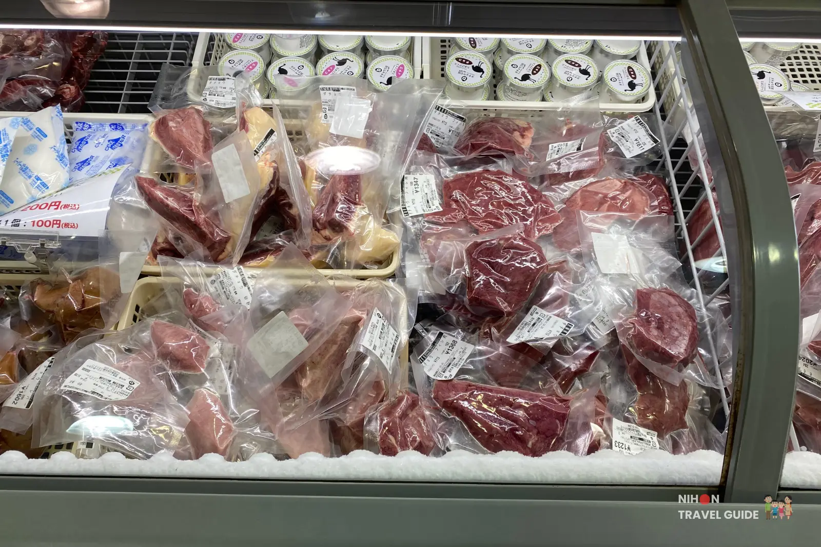 Closeup of vacuum packed ostrich meat cuts displayed in a freezer at Ishioka Ostrich Farm shop.