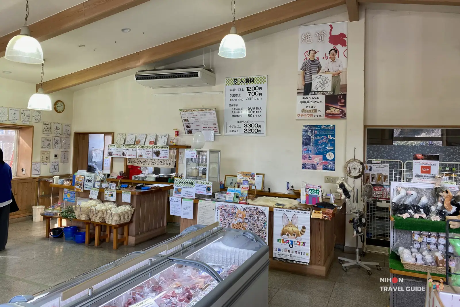 Ticket counter and menu boards inside Ishioka Ostrich Farm shop with freezer of ostrich meat in the foreground.