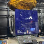 JAXA KODAMA (DRTS) satellite engineering model exhibited at Tsukuba Space Center Space Dome, showing large blue solar panel and gold thermal blanket.