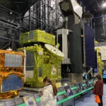 A few large JAXA communications satellites model with gold thermal blankets and parabolic antenna at Tsukuba Space Center Space Dome.