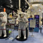 Astronaut spacesuit exhibits and Kibo module model at JAXA Tsukuba Space Center Space Dome.