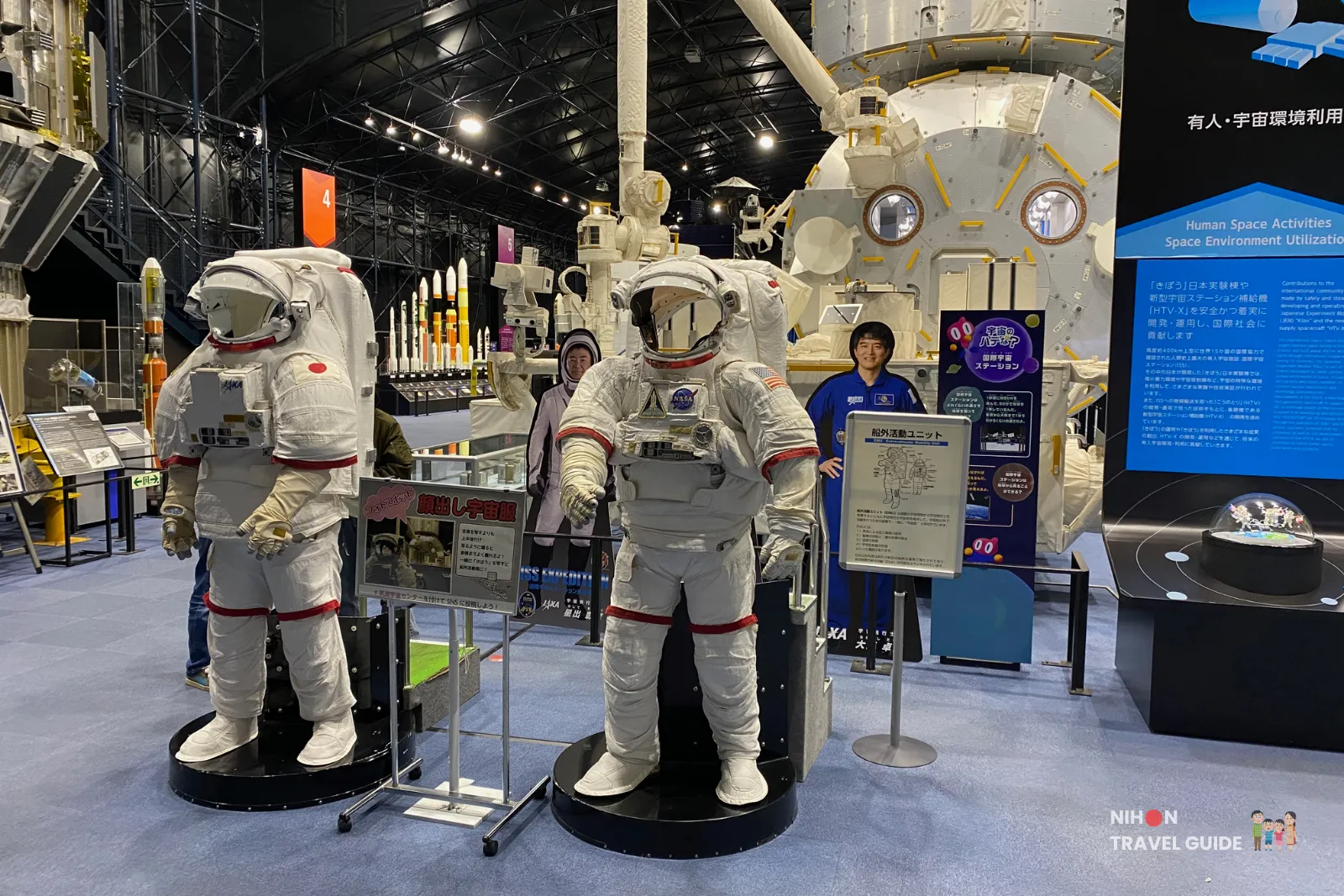 Astronaut spacesuit exhibits and Kibo module model at JAXA Tsukuba Space Center Space Dome.