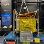 Model of the BS ‘Yuri’ broadcasting satellite wrapped in gold thermal foil on display inside the Space Dome at JAXA Tsukuba Space Center.