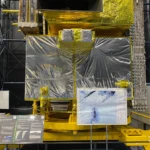 Full-scale model of JAXA’s ALOS-2 ‘Daichi-2’ Earth observation satellite wrapped in silver and gold thermal foil with a sample radar image display inside the Space Dome at Tsukuba Space Center.