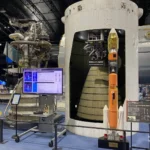 Large LE-7 rocket engine display and cross-section of an H-IIA launch vehicle second stage with a scale H-IIA rocket model inside the Space Dome at JAXA Tsukuba Space Center.