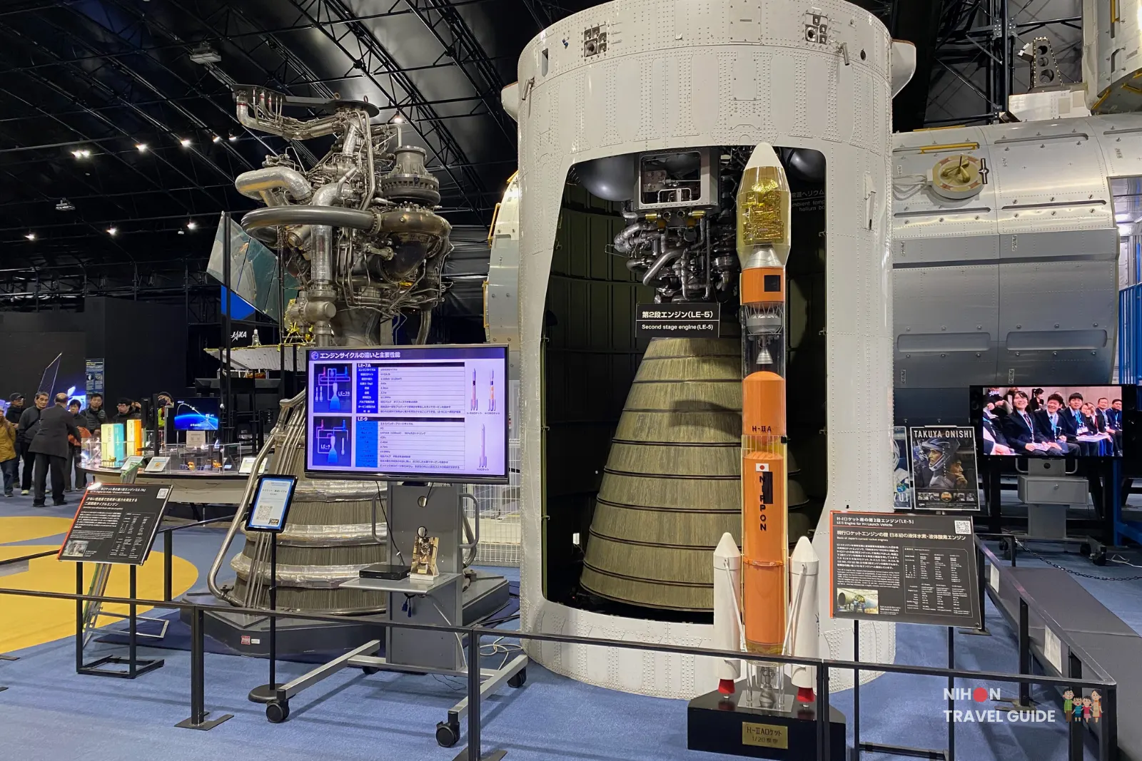 Large LE-7 rocket engine display and cross-section of an H-IIA launch vehicle second stage with a scale H-IIA rocket model inside the Space Dome at JAXA Tsukuba Space Center.