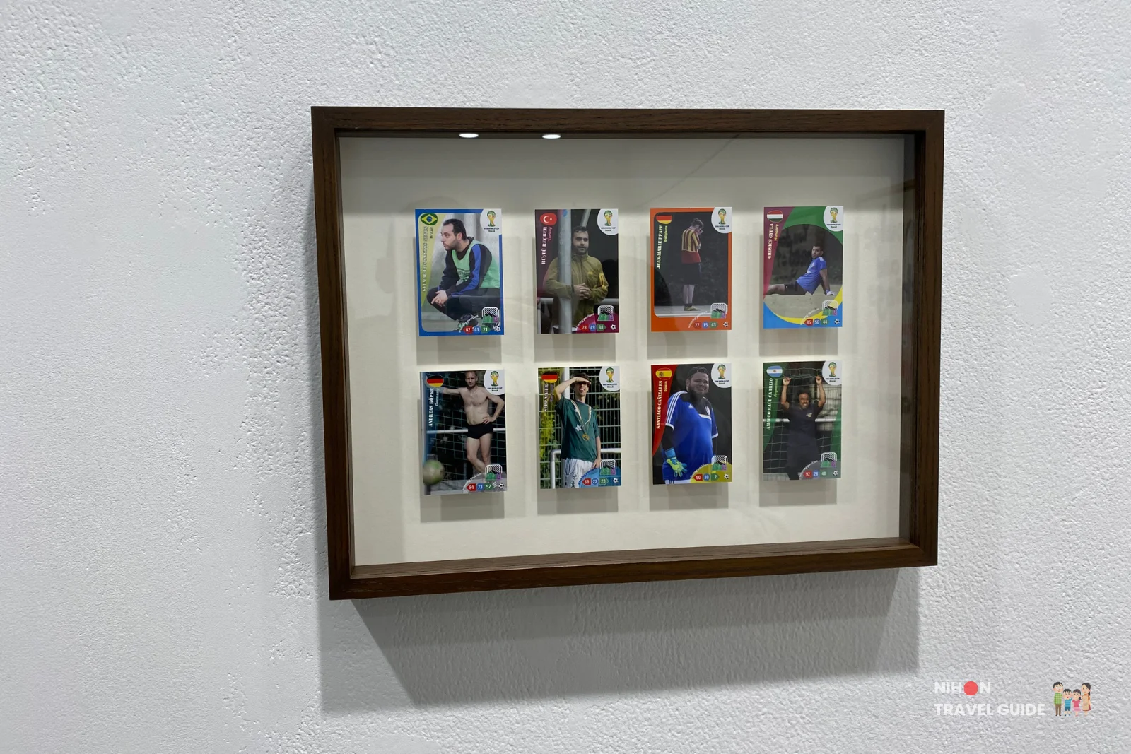 Framed collection of international soccer player trading cards displayed as artwork by Takehiro Iikawa in the “Gathering Matters and Mediations” exhibition at Art Tower Mito.