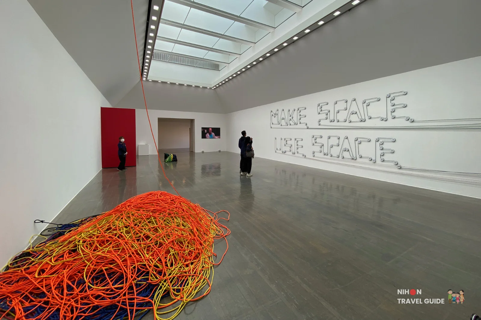 Wall installation spelling "MAKE SPACE" and "USE SPACE" using metal chain links in the Takehiro Iikawa "Gathering Matters and Mediations" exhibition at Art Tower Mito.