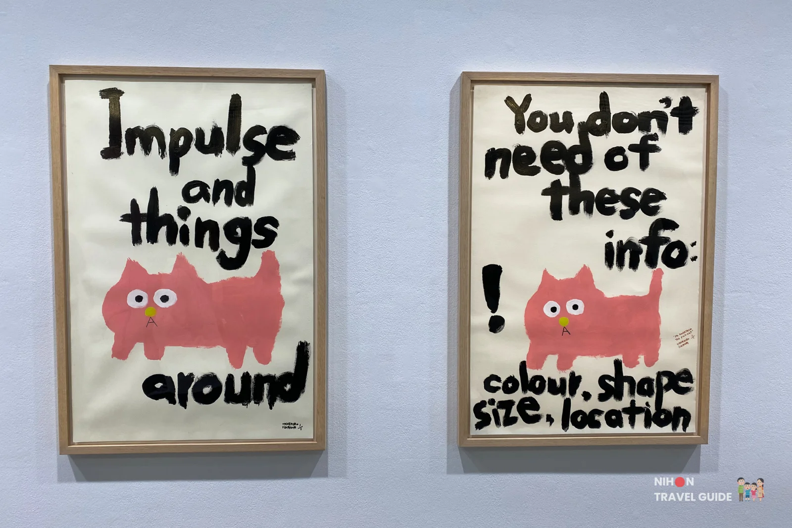 Two framed text pieces with pink cat illustrations by Takehiro Iikawa reading “Impulse and things around” and “You don’t need of these info” in the “Gathering Matters and Mediations” exhibition.