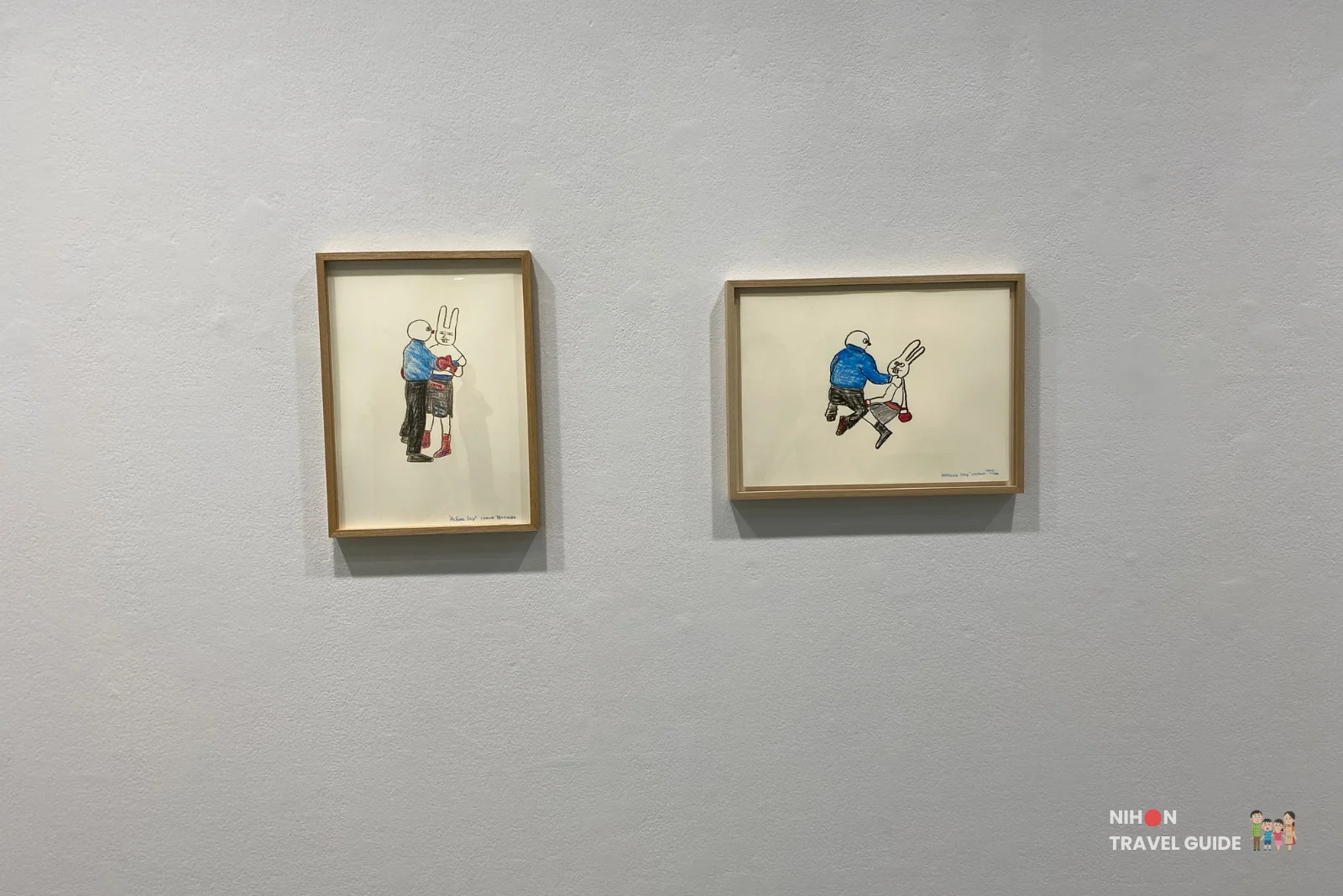 Pair of small framed drawings with rabbit-masked figures by Takehiro Iikawa, part of “Gathering Matters and Mediations” at Art Tower Mito.