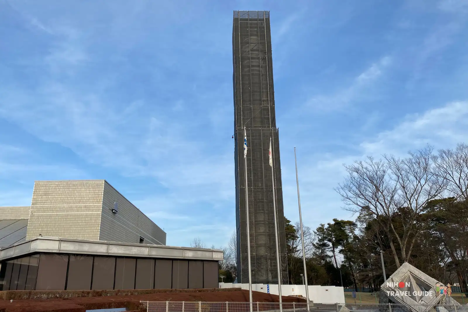 Full-scale model of the H-II rocket standing tall next to the Tsukuba Expo Center building. This 50-meter-high replica is one of the most impressive outdoor exhibits at the science museum.
