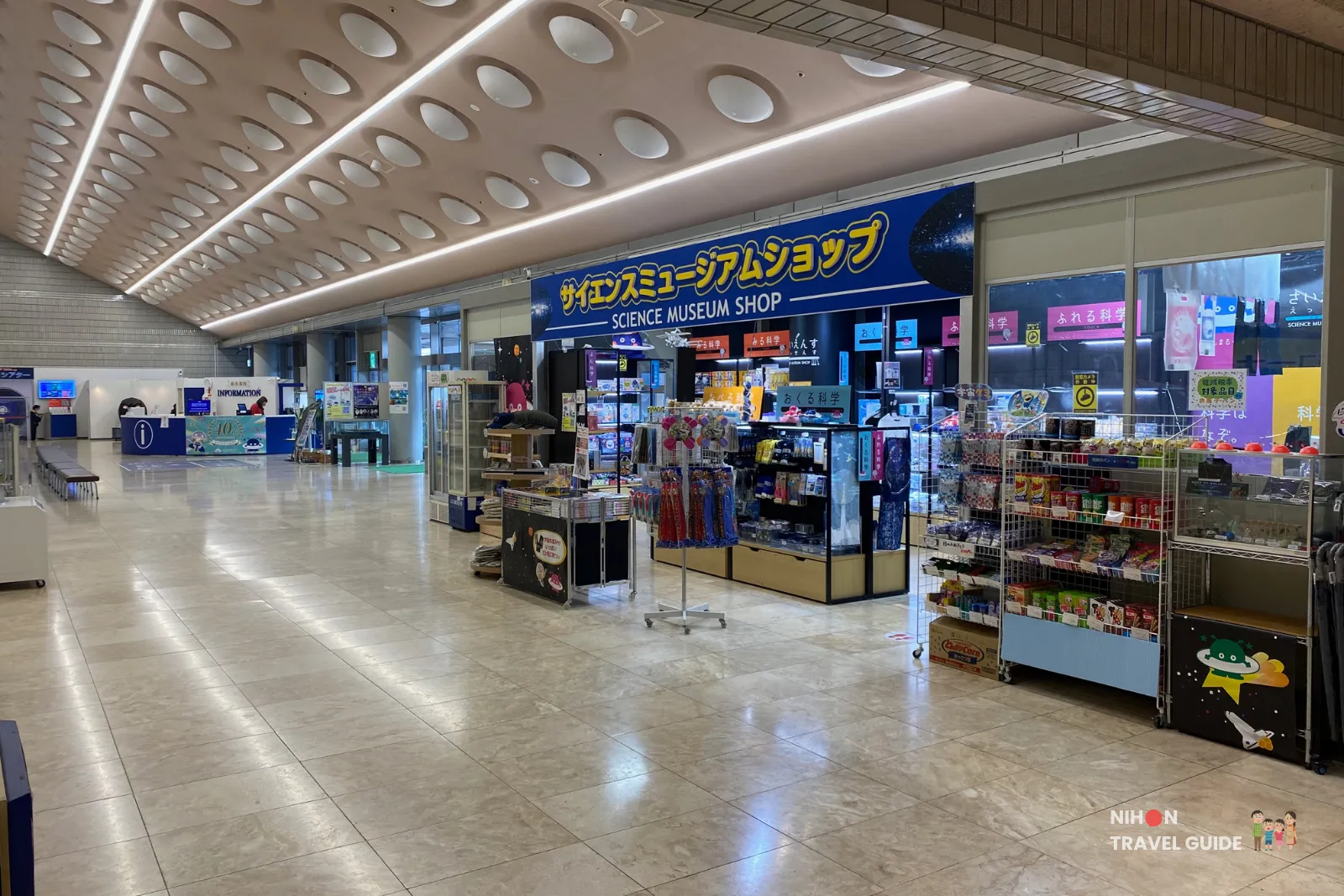 Interior of the Science Museum Shop inside Tsukuba Expo Center. The spacious store sells science toys, space merchandise, educational items, and souvenirs under a large blue sign.