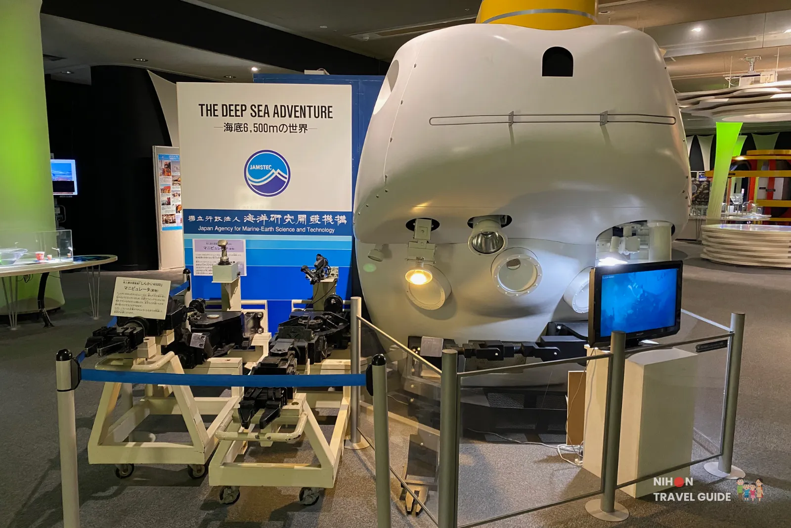Detailed model of a planetary exploration robot or rover on the second floor, displayed with monitors and related space technology exhibits.
