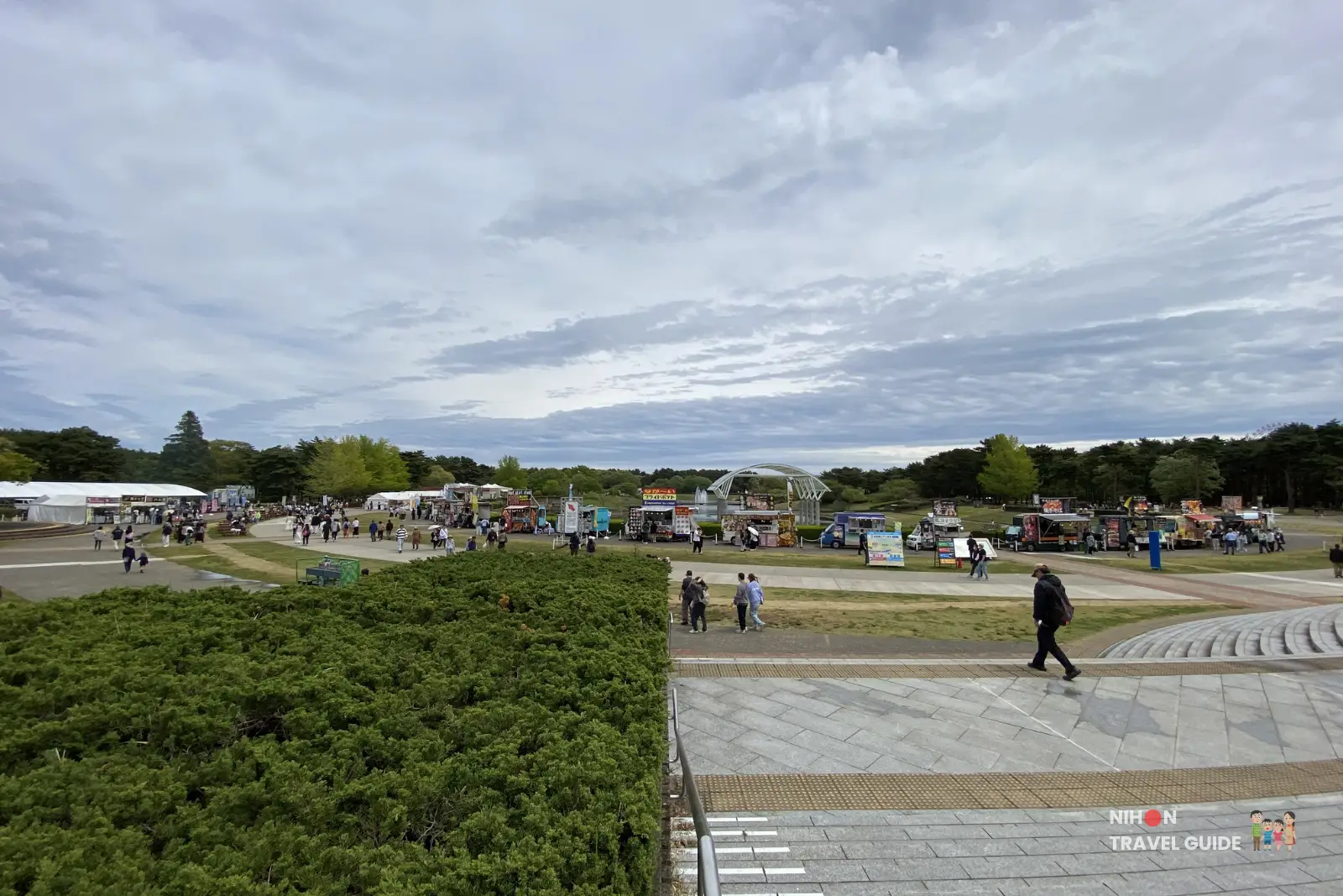 Food trucks and stalls area at Hitachi Seaside Park with many visitors enjoying various foods during the spring flower season.
