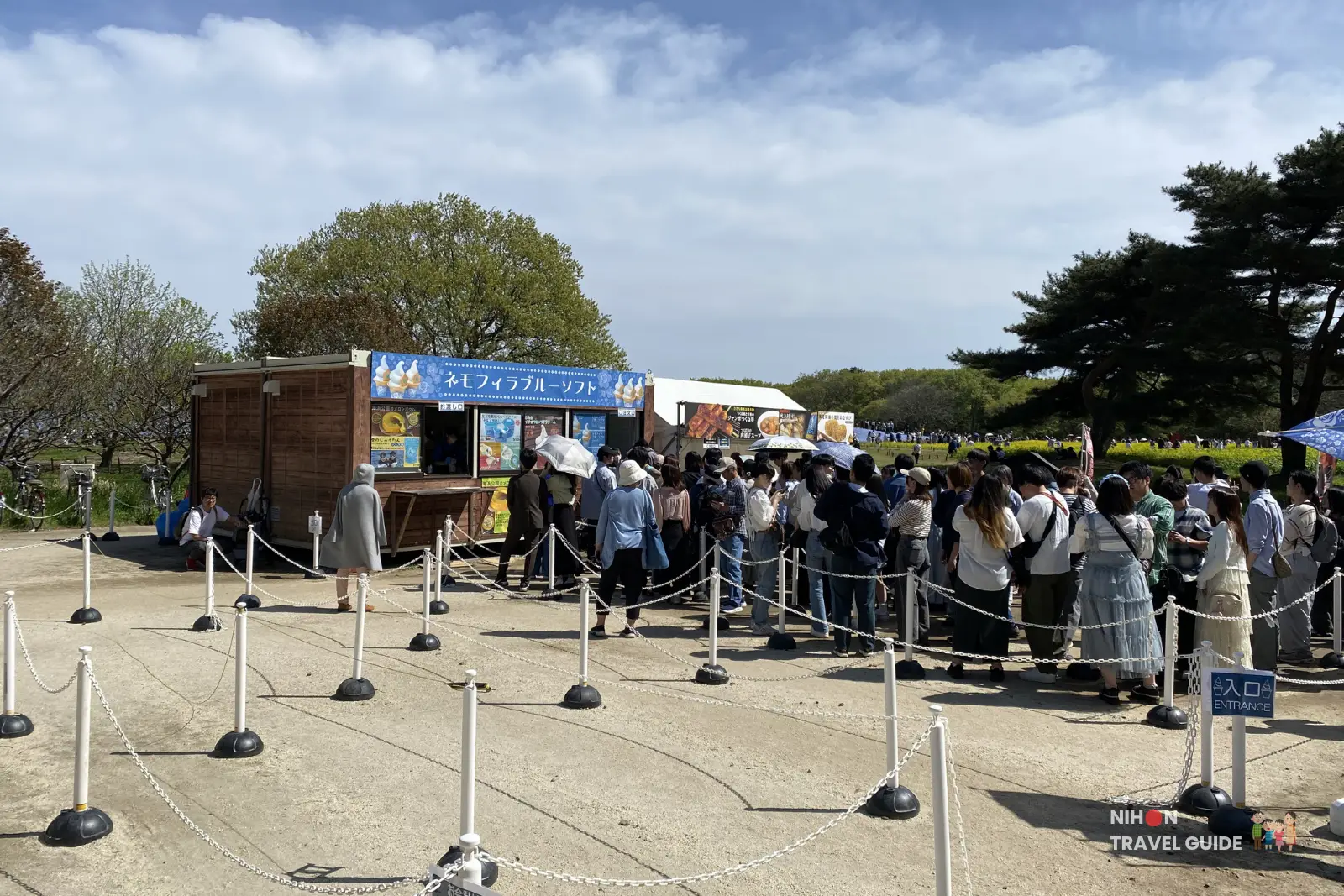 Long queue of visitors waiting to buy Nemophila Blue Soft Serve at Hitachi Seaside Park. The popular seasonal ice cream stall near the flower fields.