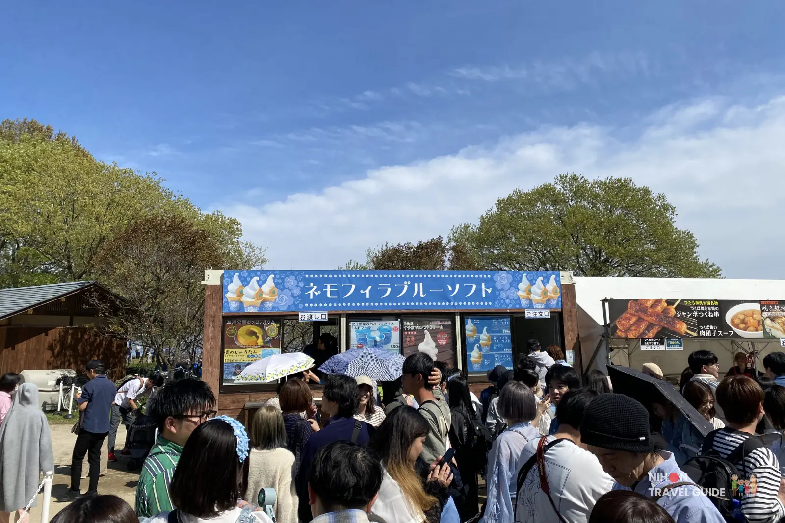 Nemophila Blue Soft Serve stall at Hitachi Seaside Park during peak season. A popular food stall selling the iconic blue soft serve ice cream with long queues of visitors.