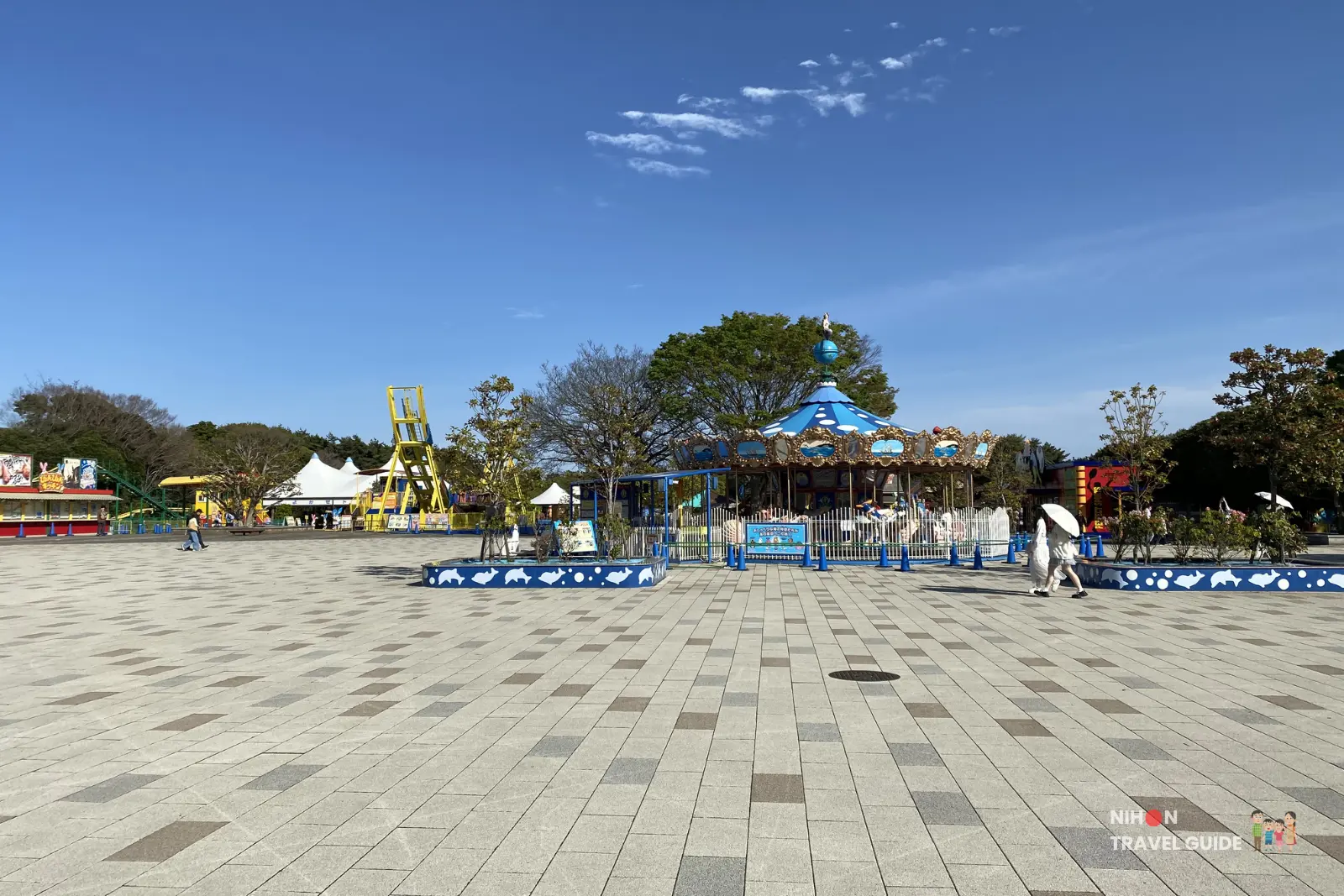 Blue and white carousel in the Pleasure Garden at Hitachi Seaside Park on a sunny day.