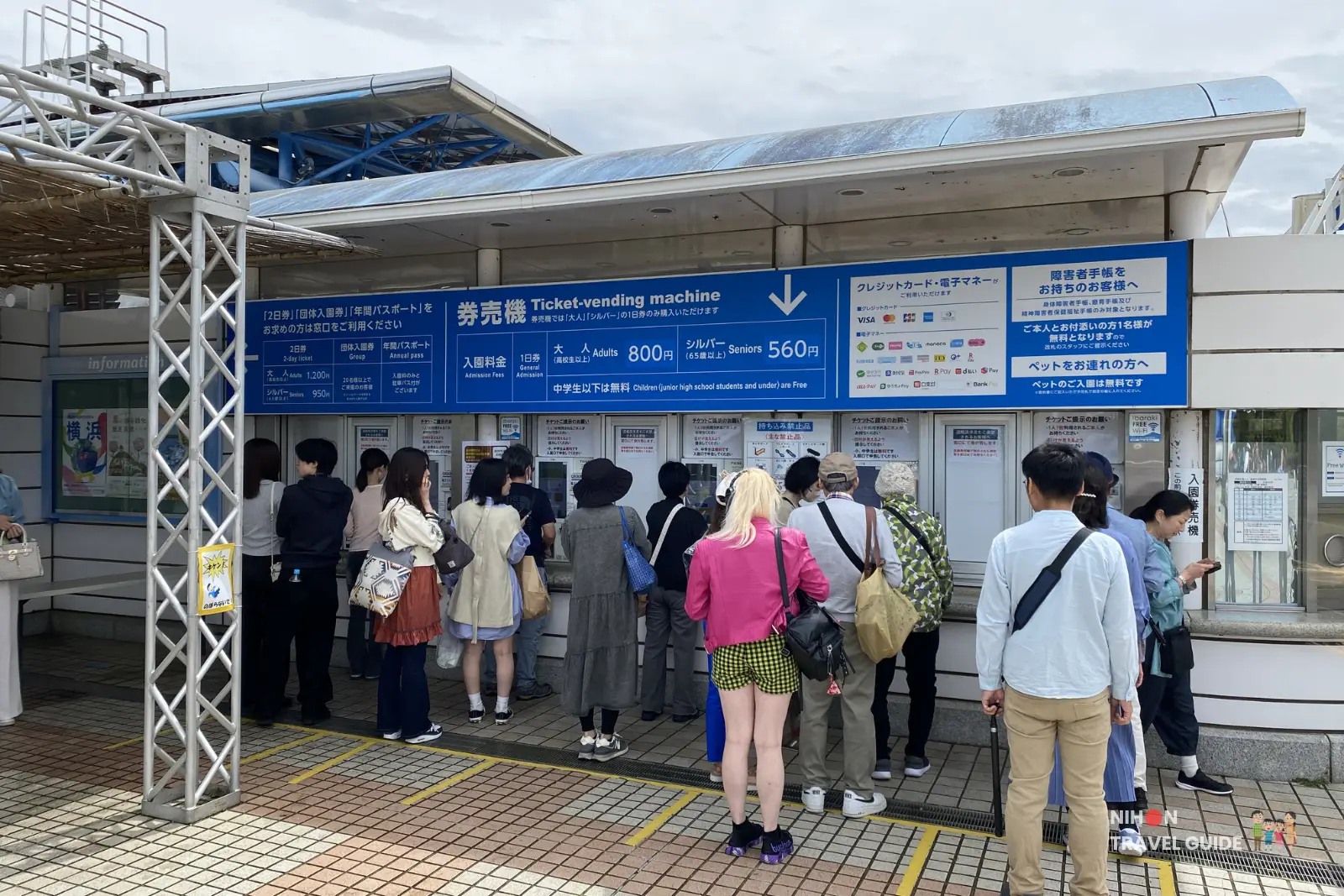 Ticket vending machines and entrance counter at Hitachi Seaside Park. Visitors lining up to purchase admission tickets during the spring season.