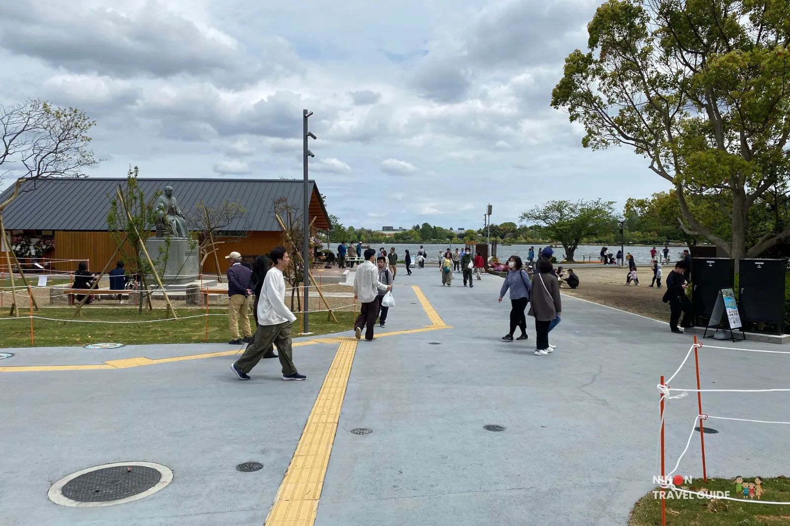 lake-senba-promenade-mito-kobun-terrace Open lakeside walkway at Mito Kobun Terrace with statue and Lake Senba in the background.