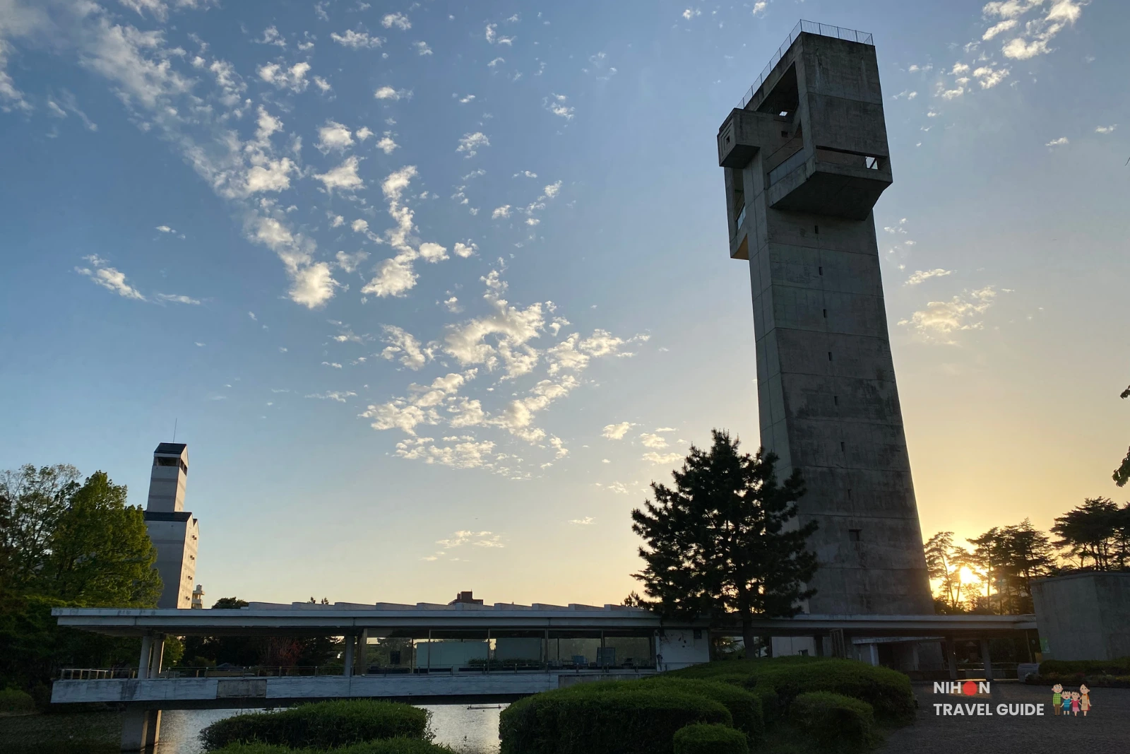 Tall concrete observation tower at Matsumi Park in Tsukuba, silhouetted against a beautiful sunset sky.