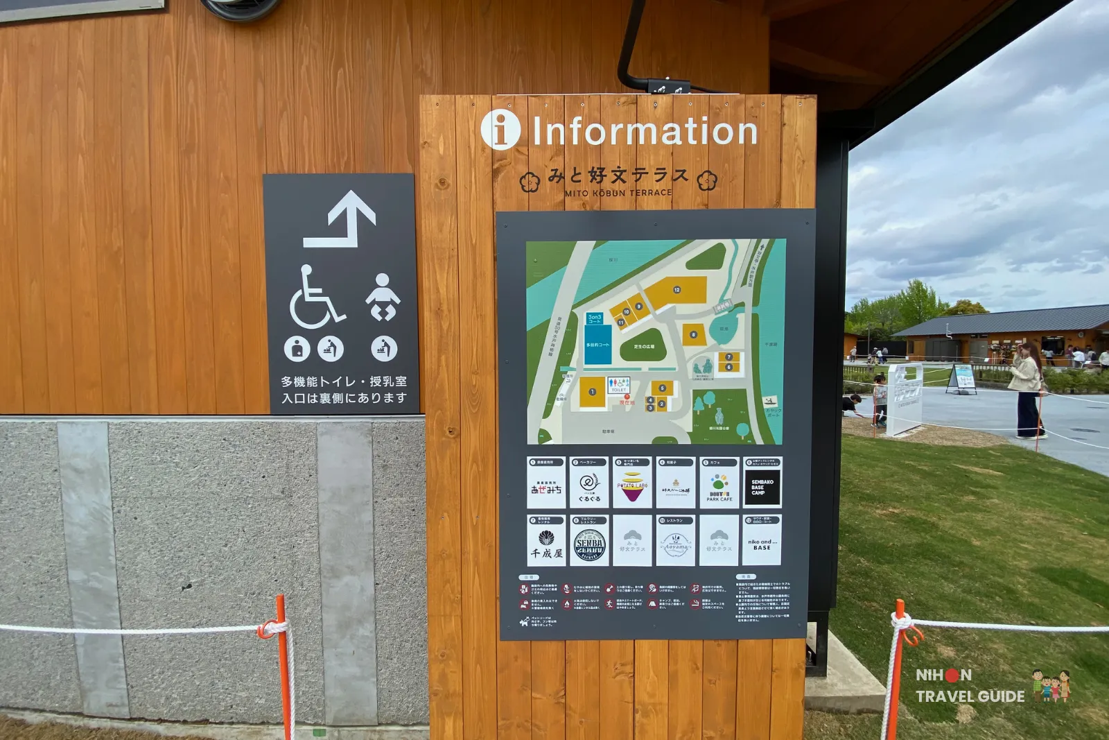 Information board and site map at Mito Kobun Terrace, showing the layout of shops, facilities, and accessible toilets near Lake Senba.