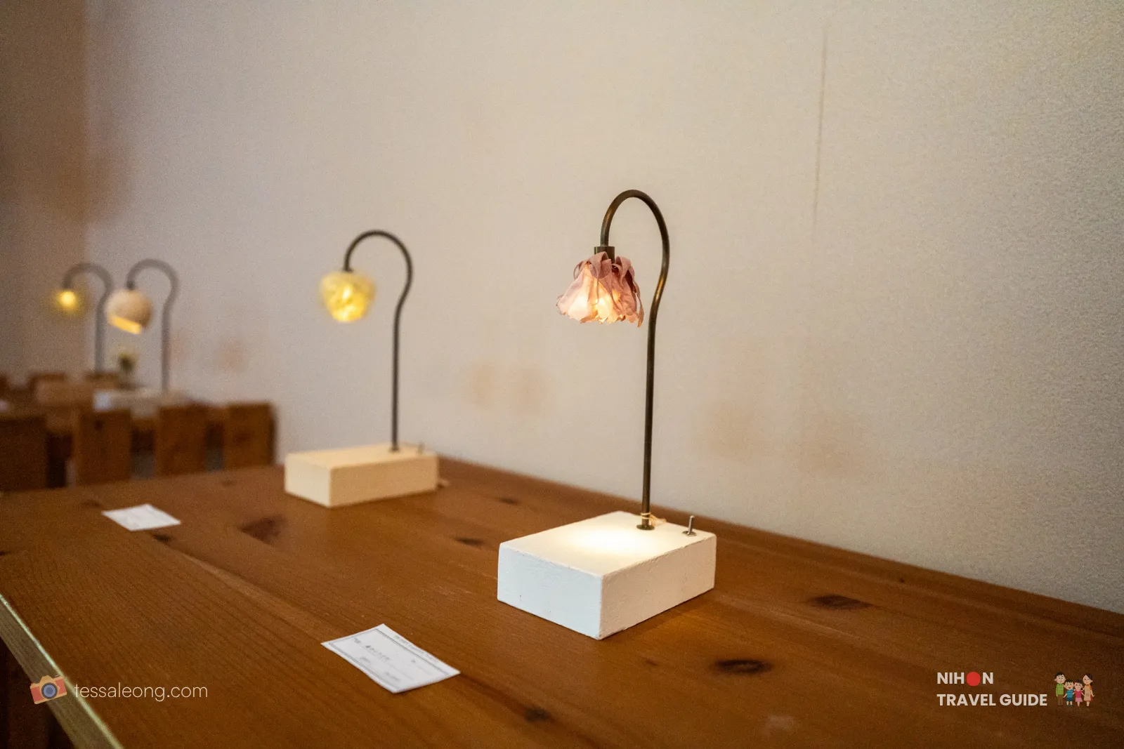 Decorative handmade lamps with dried peony flower shades on wooden bases, displayed for sale inside the shop at Peony Garden Tokyo.