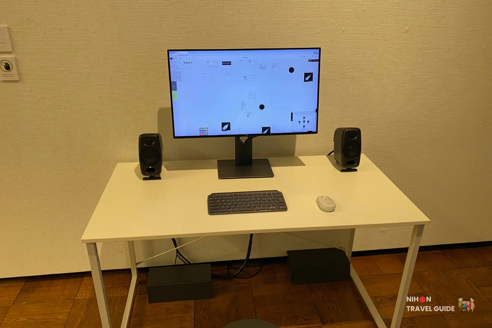 Close-up of the interactive computer desk for Polytape by Taisuke Naganawa showing monitor with node-based music app, keyboard, mouse and speakers