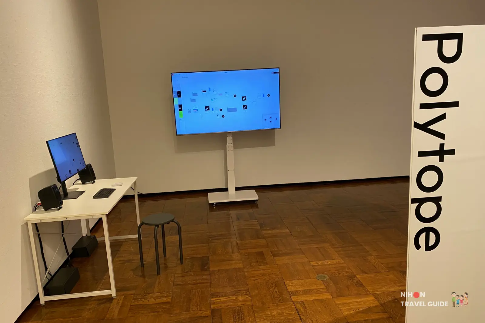 Polytape interactive station by Taisuke Naganawa — white desk with computer, keyboard, speakers and large monitor displaying the node-based web app at the University of Tsukuba Master’s Degree Exhibition