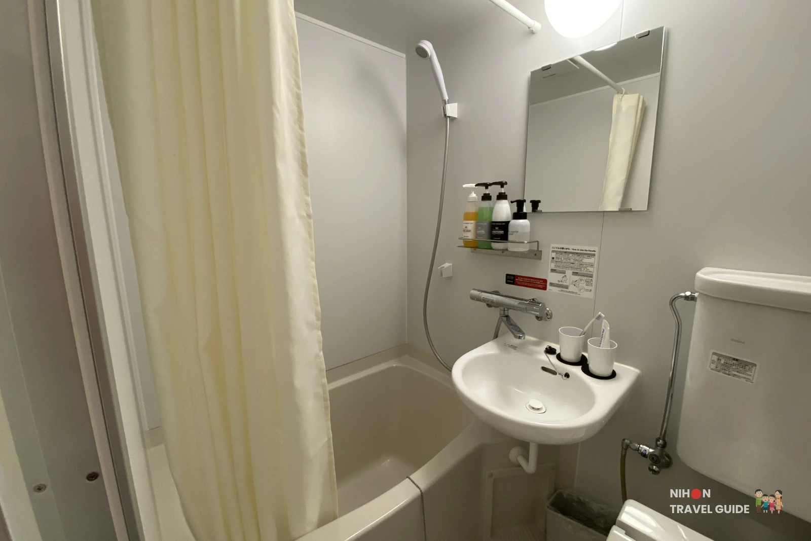 Compact bathroom featuring bathtub with shower, sink, and toiletries at R9 The Yard Hotel Hitachinaka Ichige