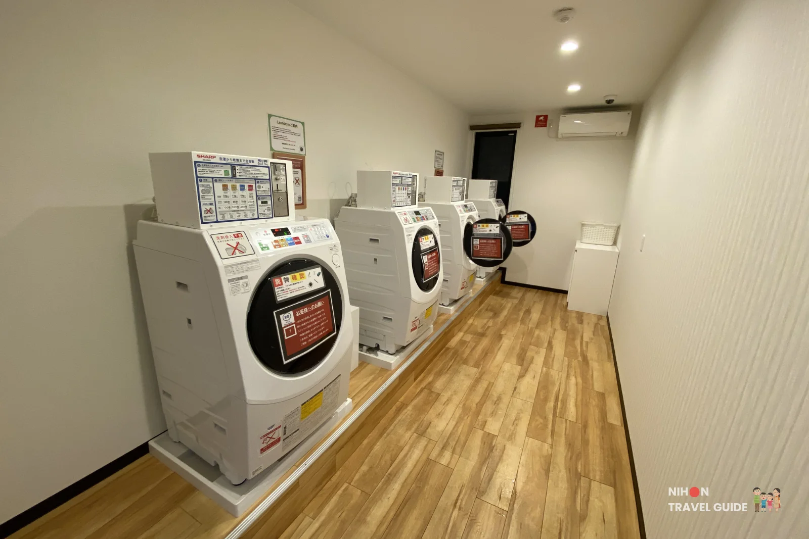 Clean coin laundry room with multiple Sharp washing machines and dryers at R9 The Yard Hotel Hitachinaka Ichige in Ibaraki, Japan
