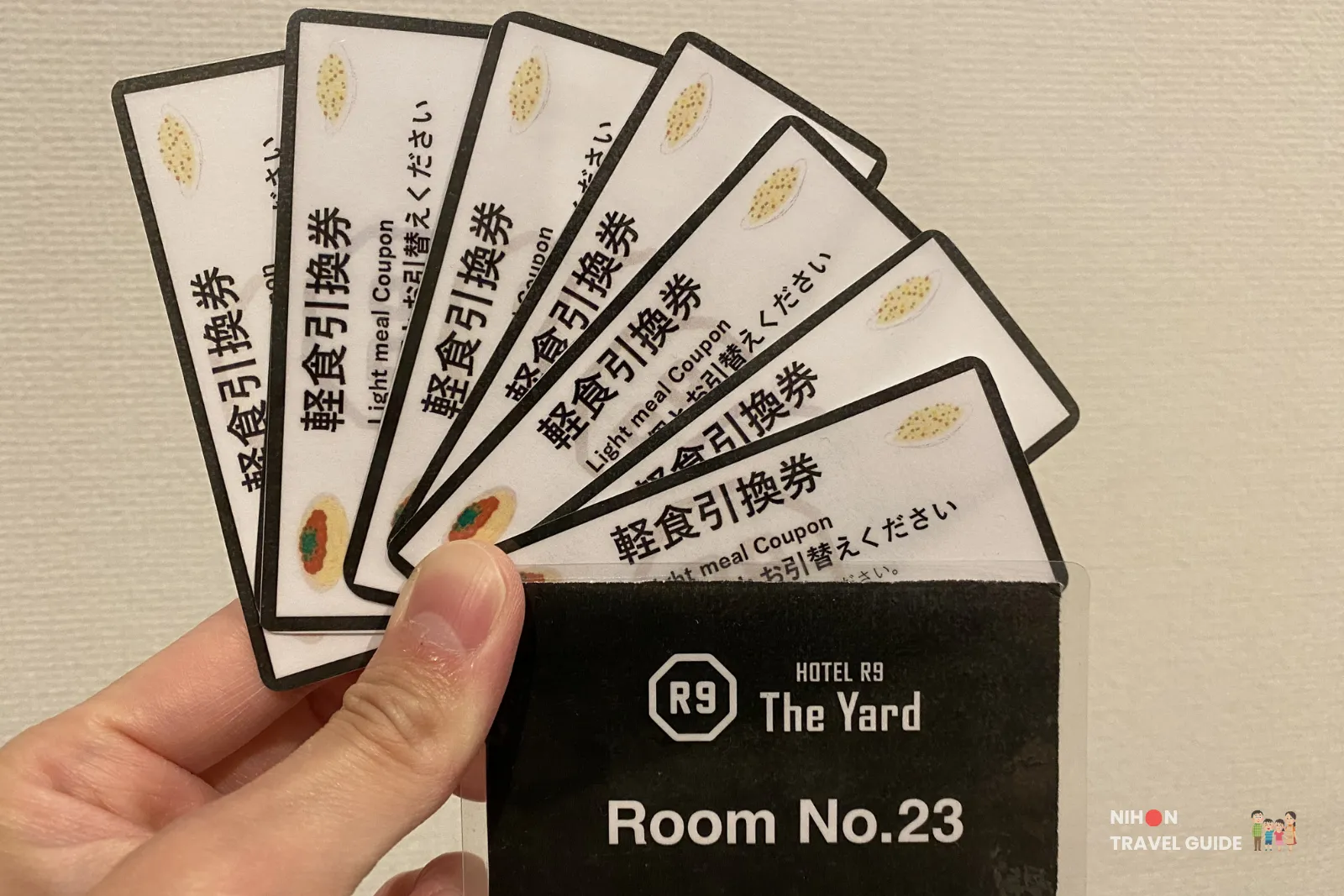 Guest holding light meal coupons and room key card for Room 23 at R9 The Yard Hotel Hitachinaka Ichige