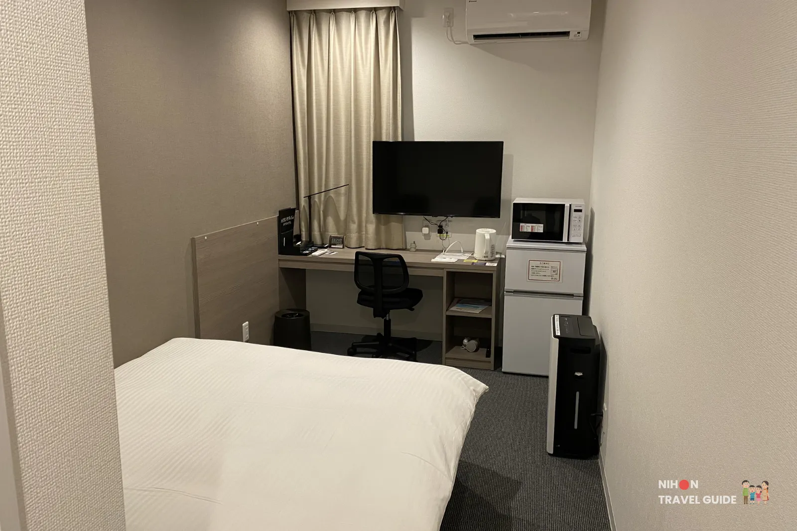 Work desk with TV, microwave, refrigerator, and air purifier in Room 23 at R9 The Yard Hotel Hitachinaka Ichige