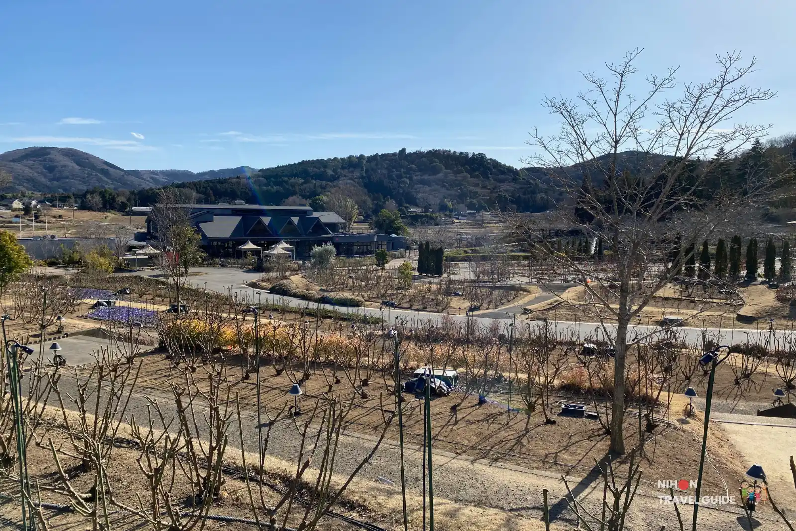 Winter overview of Ibaraki Flower Park showing the main buildings, rose gardens, and pathways.