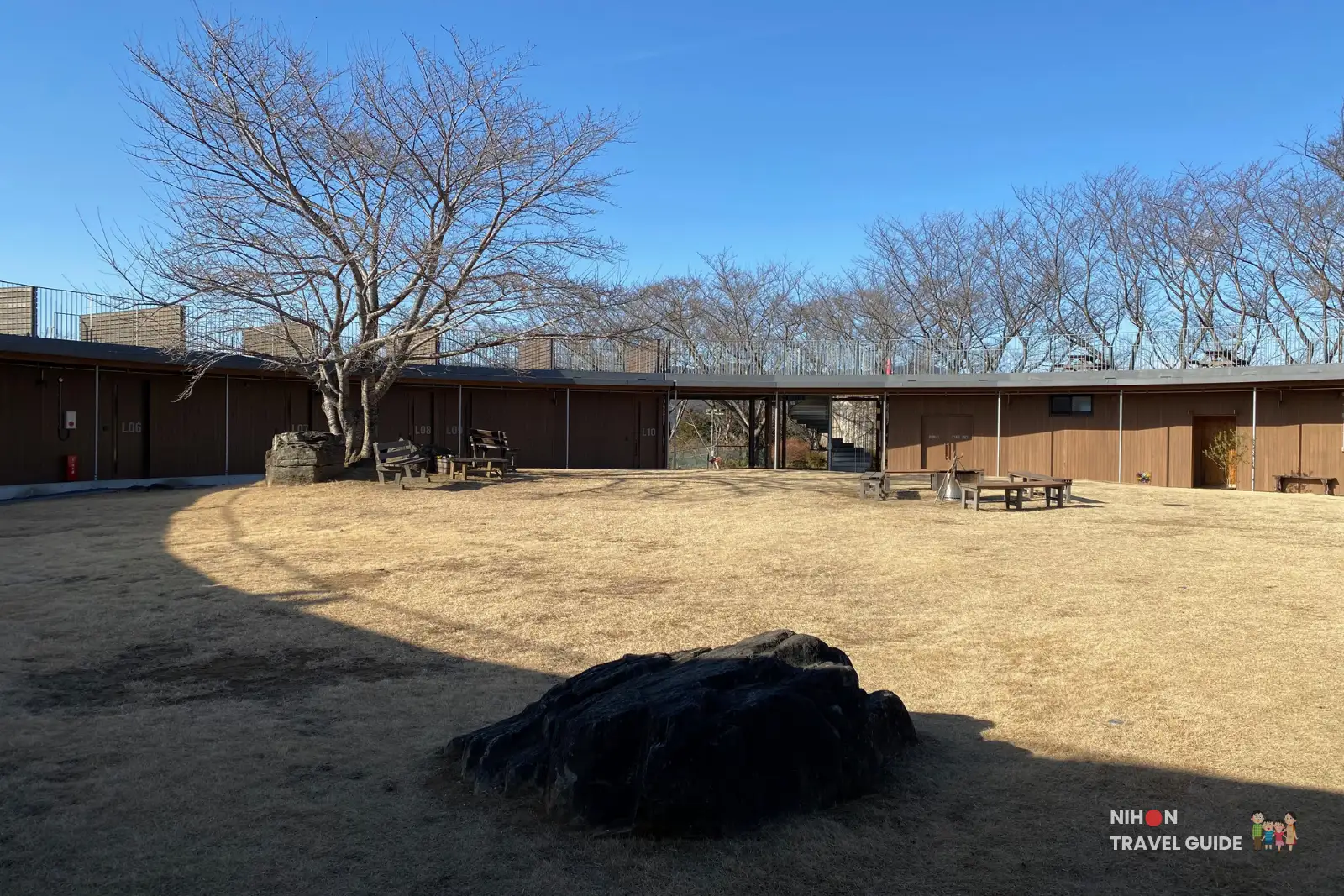 Inner courtyard and wooden lodges at Hanayasatoyama camping resort in winter at Ibaraki Flower Park.