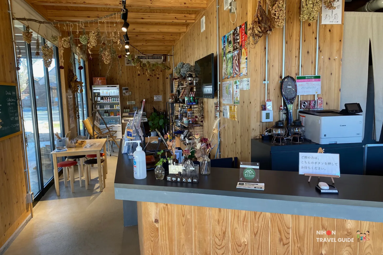 Interior of the shop and reception area at Hanayasatoyama in Ibaraki Flower Park with wooden decor and merchandise.