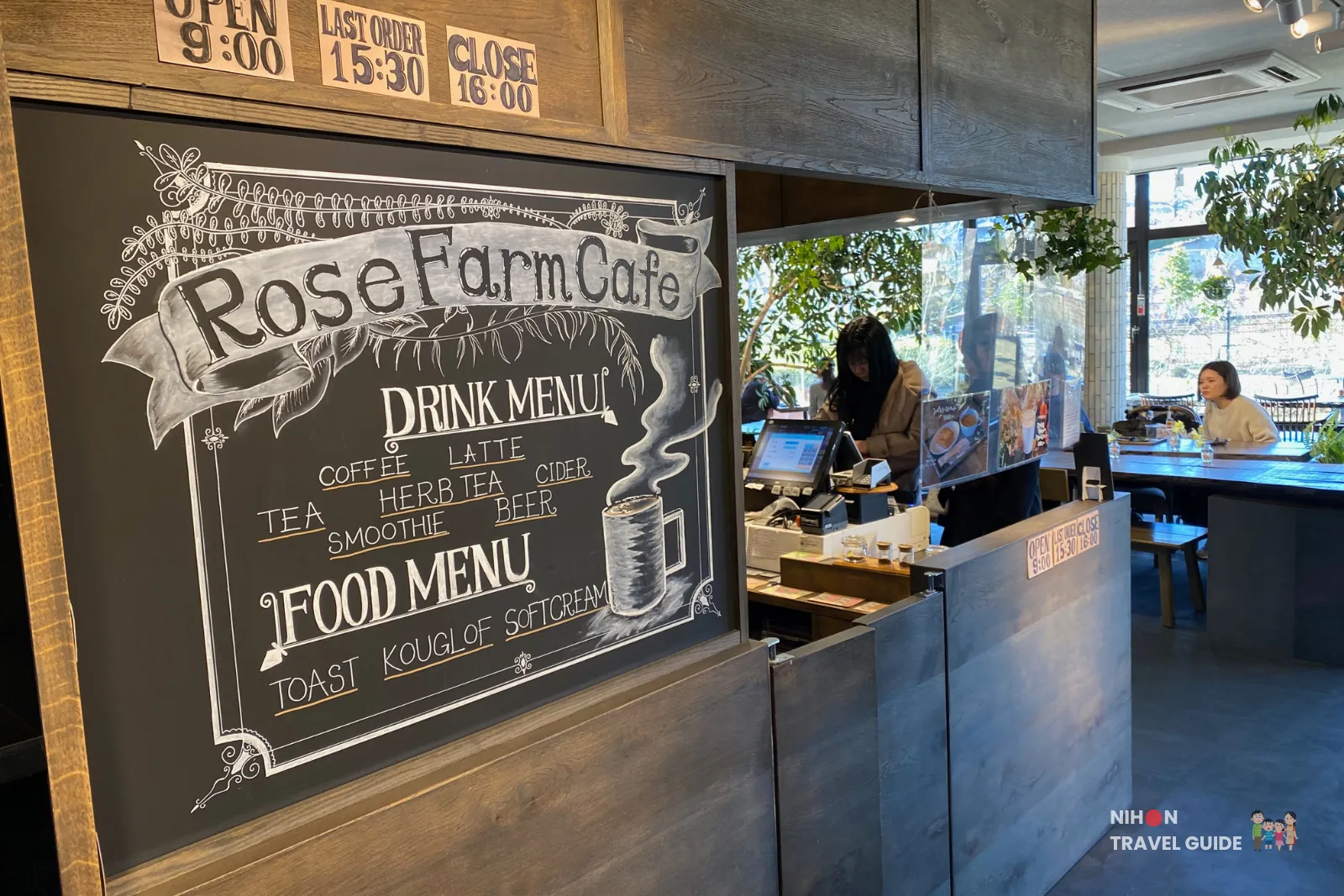 Interior of Rose Farm Café at Ibaraki Flower Park showing the chalkboard menu and counter area.