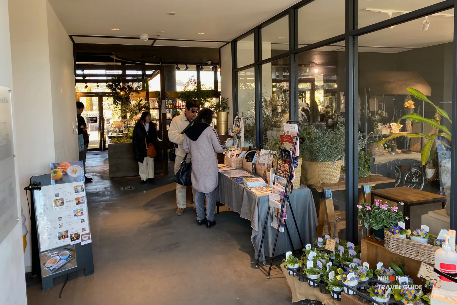 Interior of Rose Farm Market at Ibaraki Flower Park with souvenirs, plants, and shopping area.