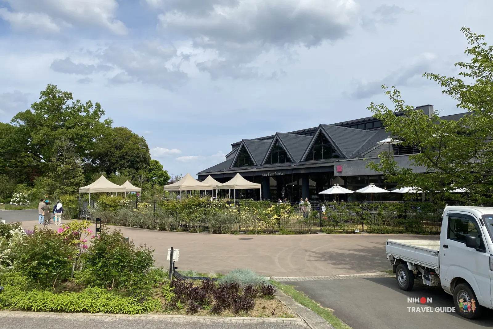 Rose Farm Market building and entrance area at Ibaraki Flower Park on a sunny day
