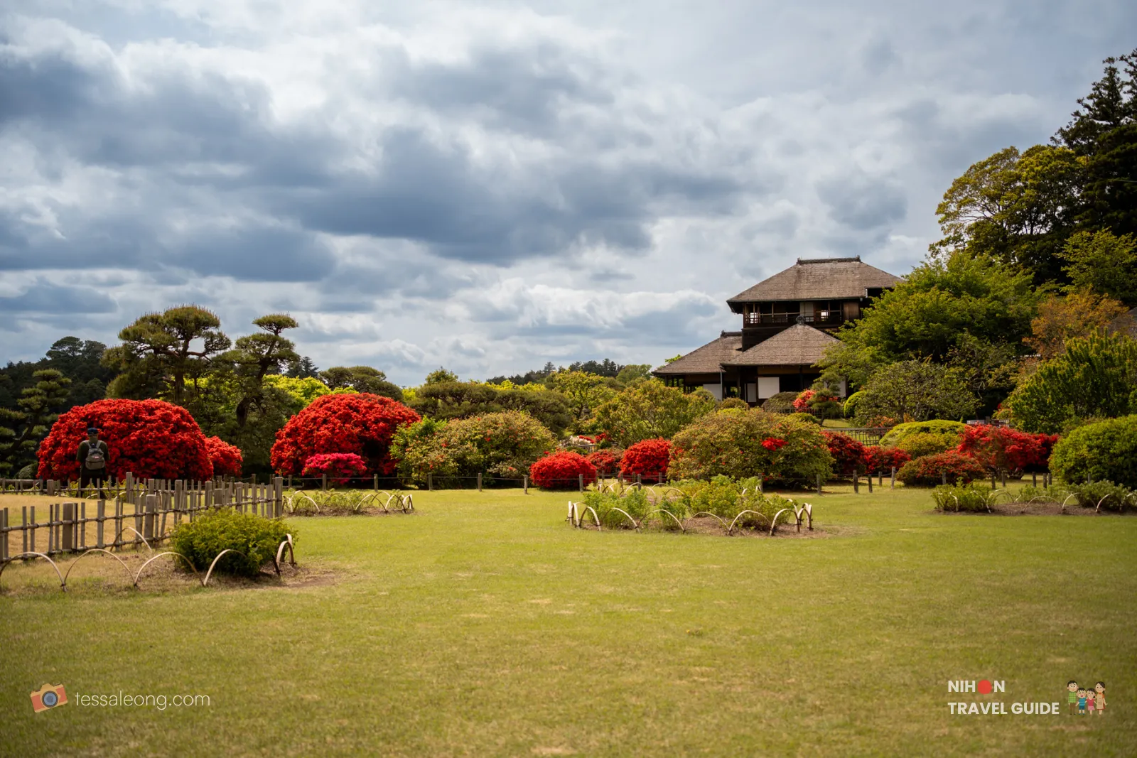 Scenic view of Kobuntei pavilion at Kairakuen Garden with vibrant red azaleas blooming in the foreground under a cloudy sky.
