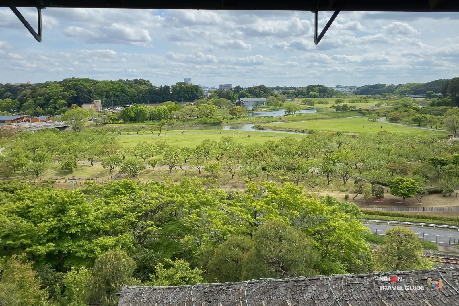 Wide panoramic view from the 3rd floor of Kobuntei overlooking Senba Park, Lake Senba, and the expansive green landscape at Kairakuen Garden.