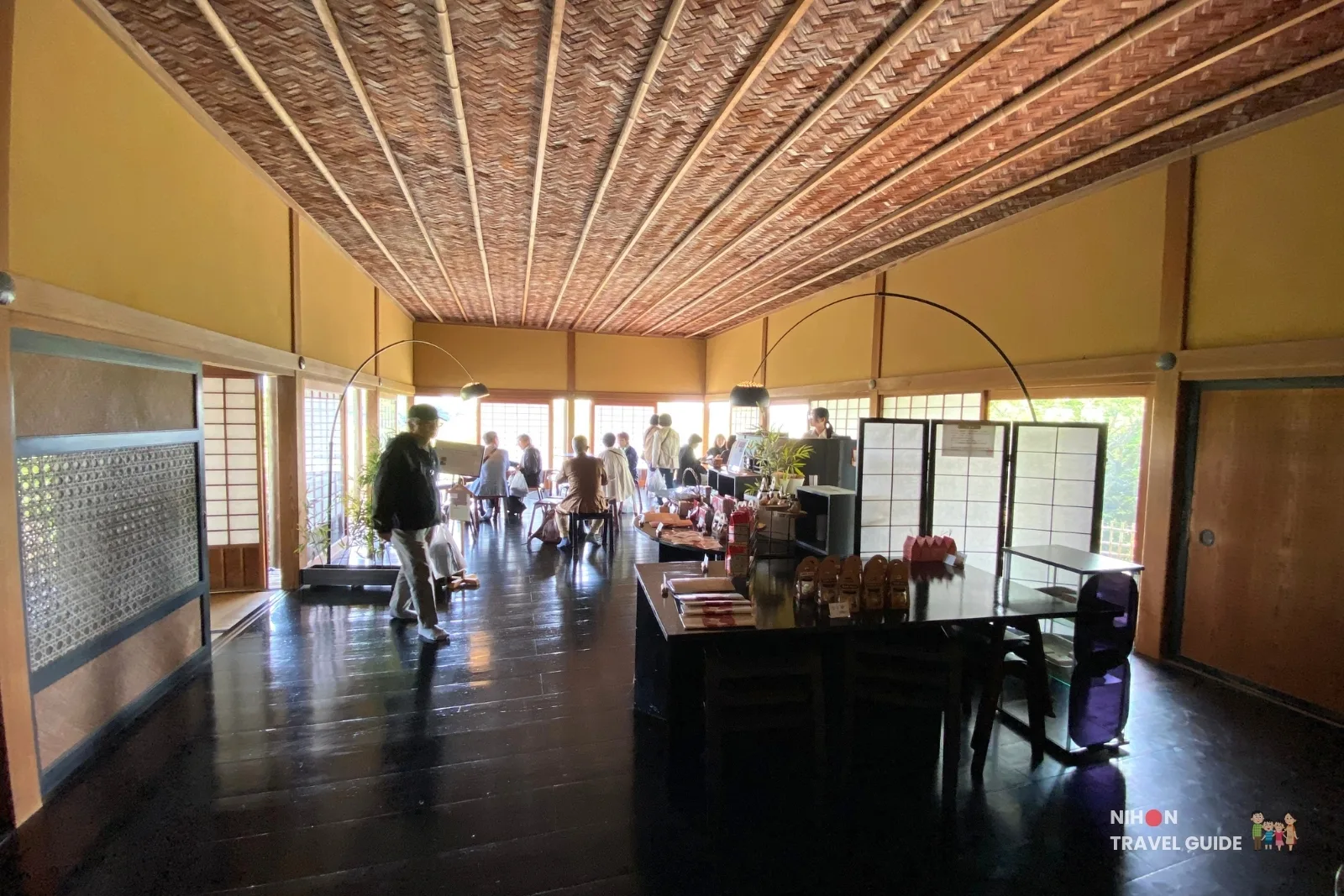 Cafe Raku seating area and counter inside Kobuntei at Kairakuen Garden, with natural light from windows overlooking the garden