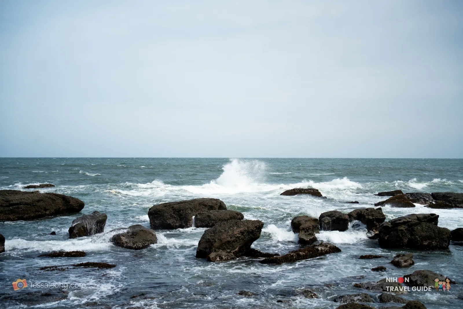 Powerful wave crashing against the dark rocks on the Pacific coastline near Oarai Isosaki Shrine in Ibaraki, Japan